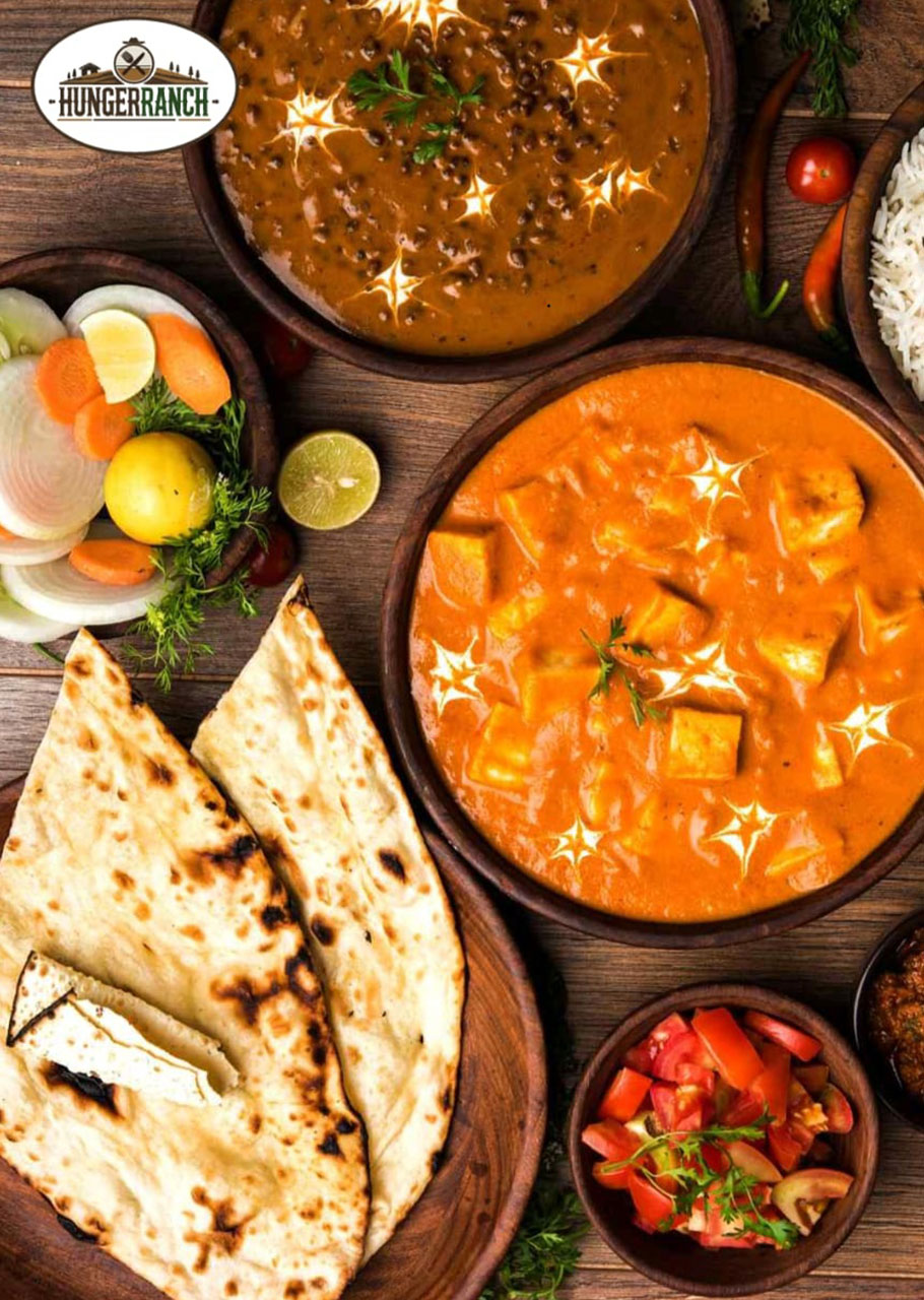 North Indian curry served with naan and sides